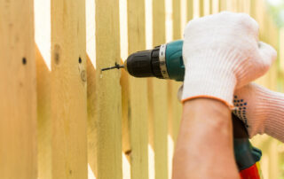 carpenter holding electric screwdriver