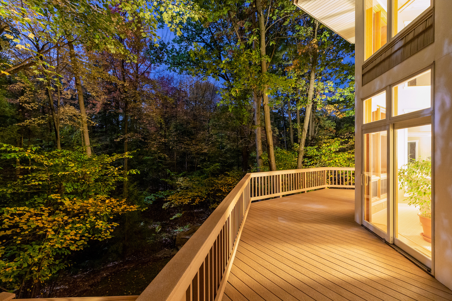 Deck on Home in Woods at Night Trex Decking | Decking Contractor
